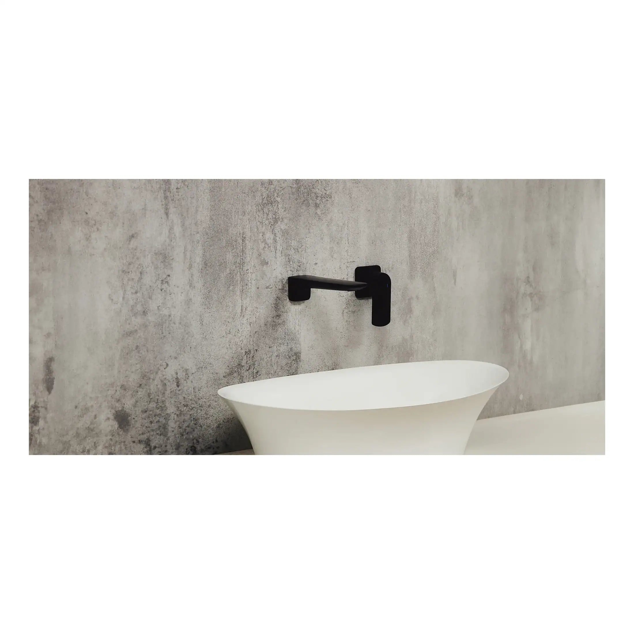 Modern freestanding white bathtub with sleek black wall-mounted faucet in a contemporary bathroom setting.