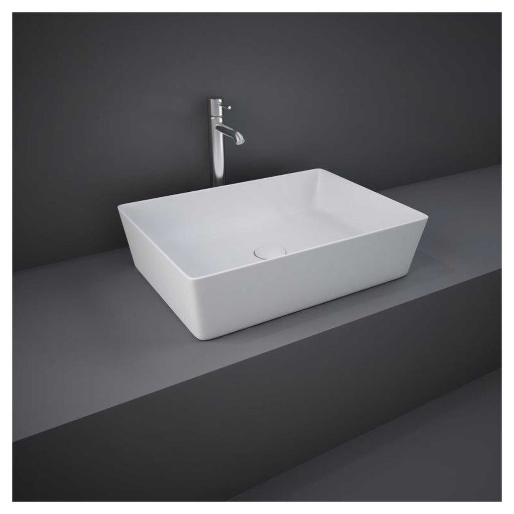 Sleek rectangular white bathroom sink with modern design and chrome faucet mounted on dark grey countertop, perfect for contemporary bathroom renovations.