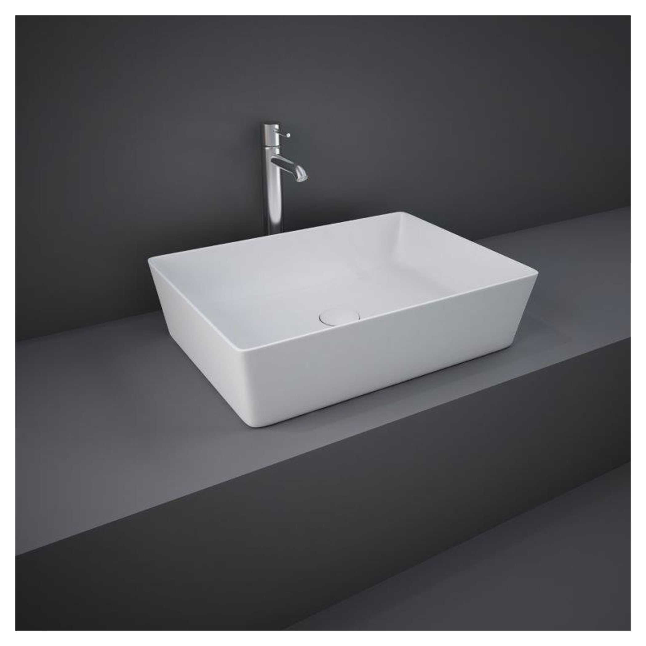 Sleek rectangular white bathroom sink with modern design and chrome faucet mounted on dark grey countertop, perfect for contemporary bathroom renovations.
