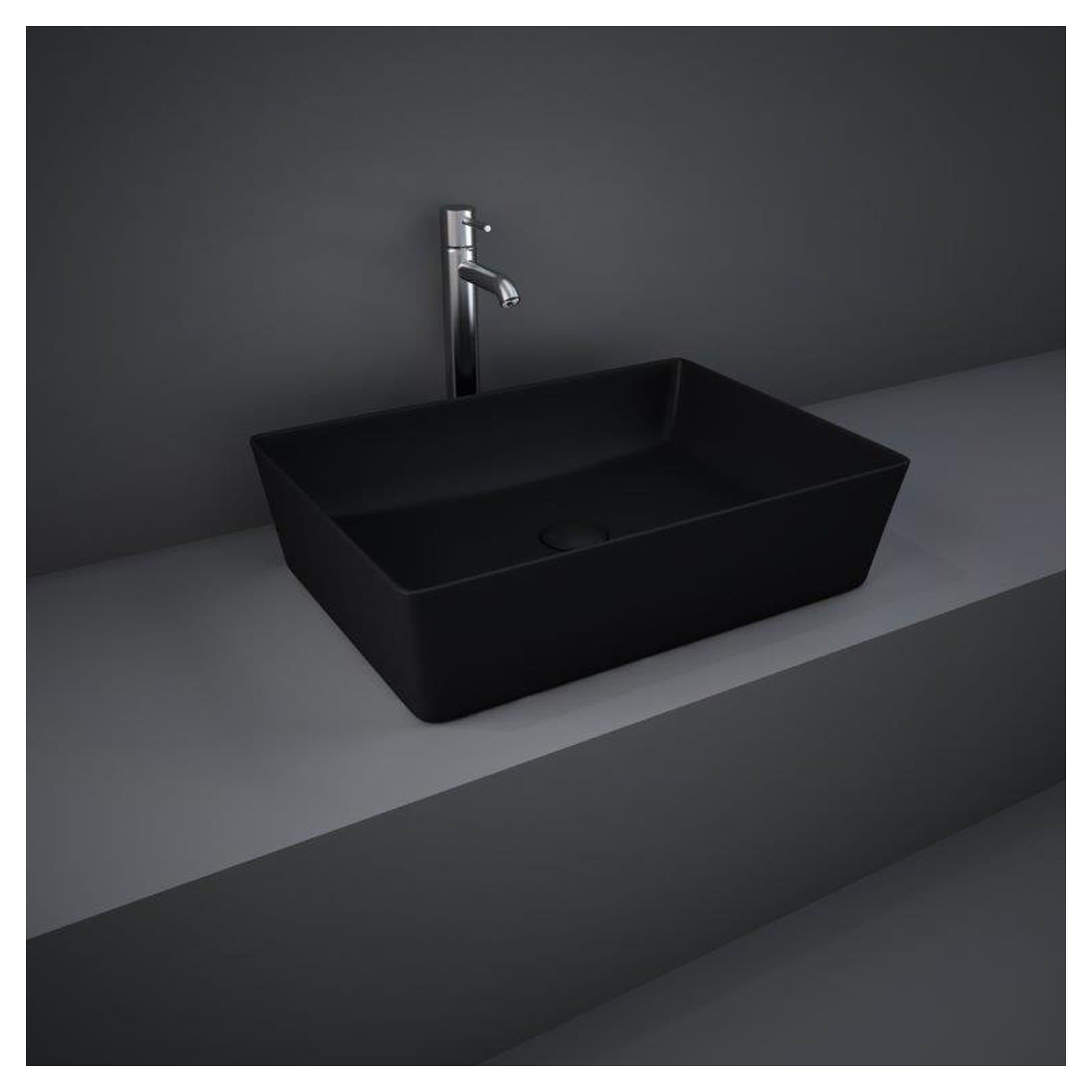 Sleek black rectangular bathroom wash basin with modern chrome tap on grey countertop, minimalist design for contemporary bathrooms.