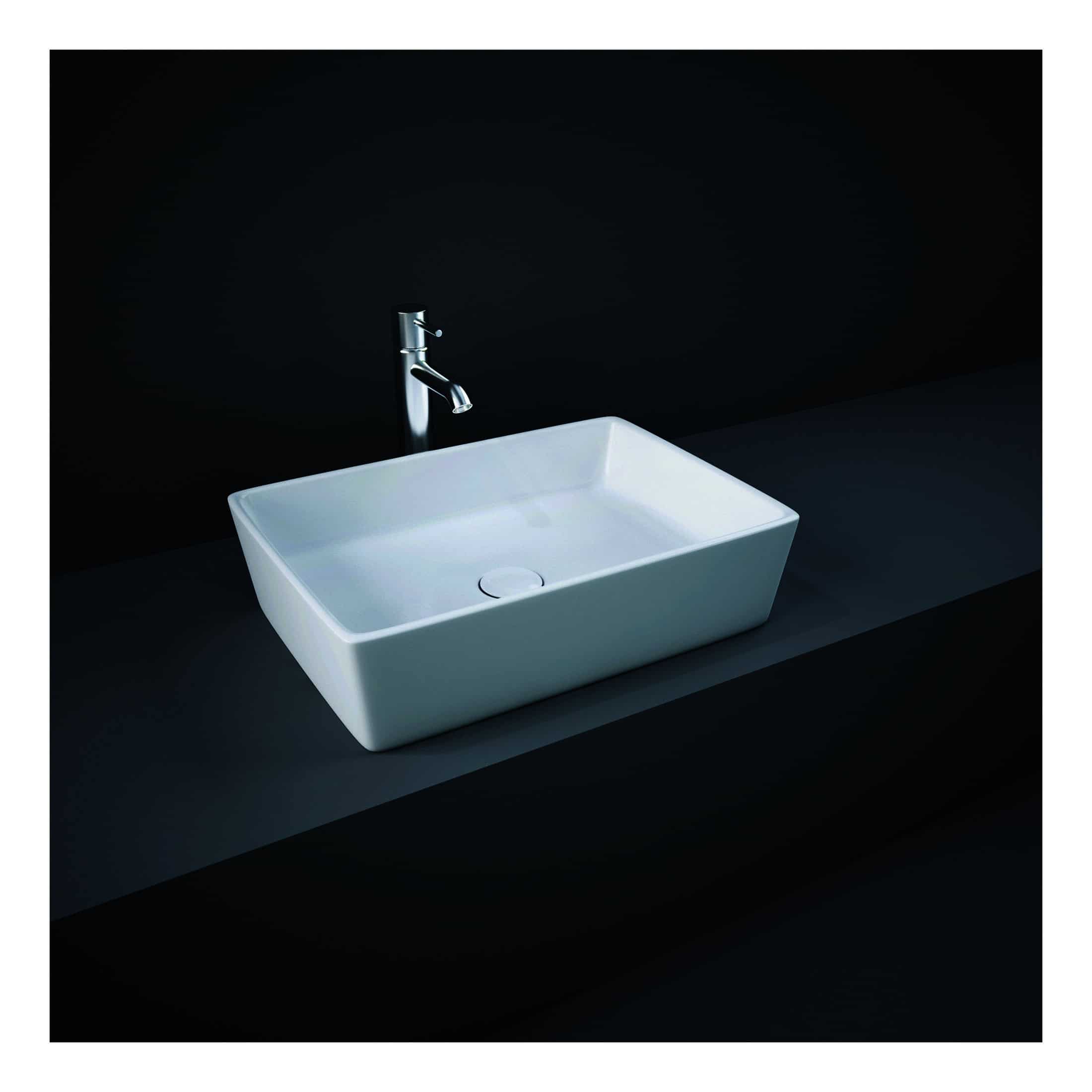 Modern square white ceramic bathroom sink with chrome faucet on dark countertop.