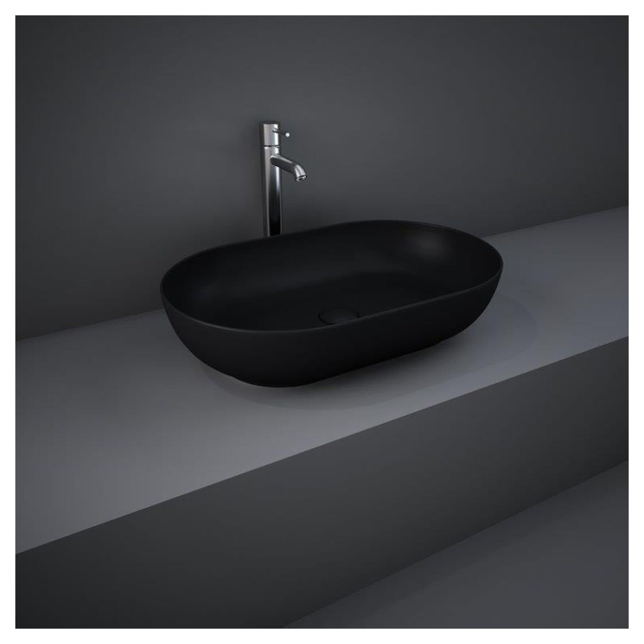 Sleek black bathroom vessel sink with modern chrome faucet on minimalist grey countertop, stylish contemporary bathroom fixture for elegant bathroom design.