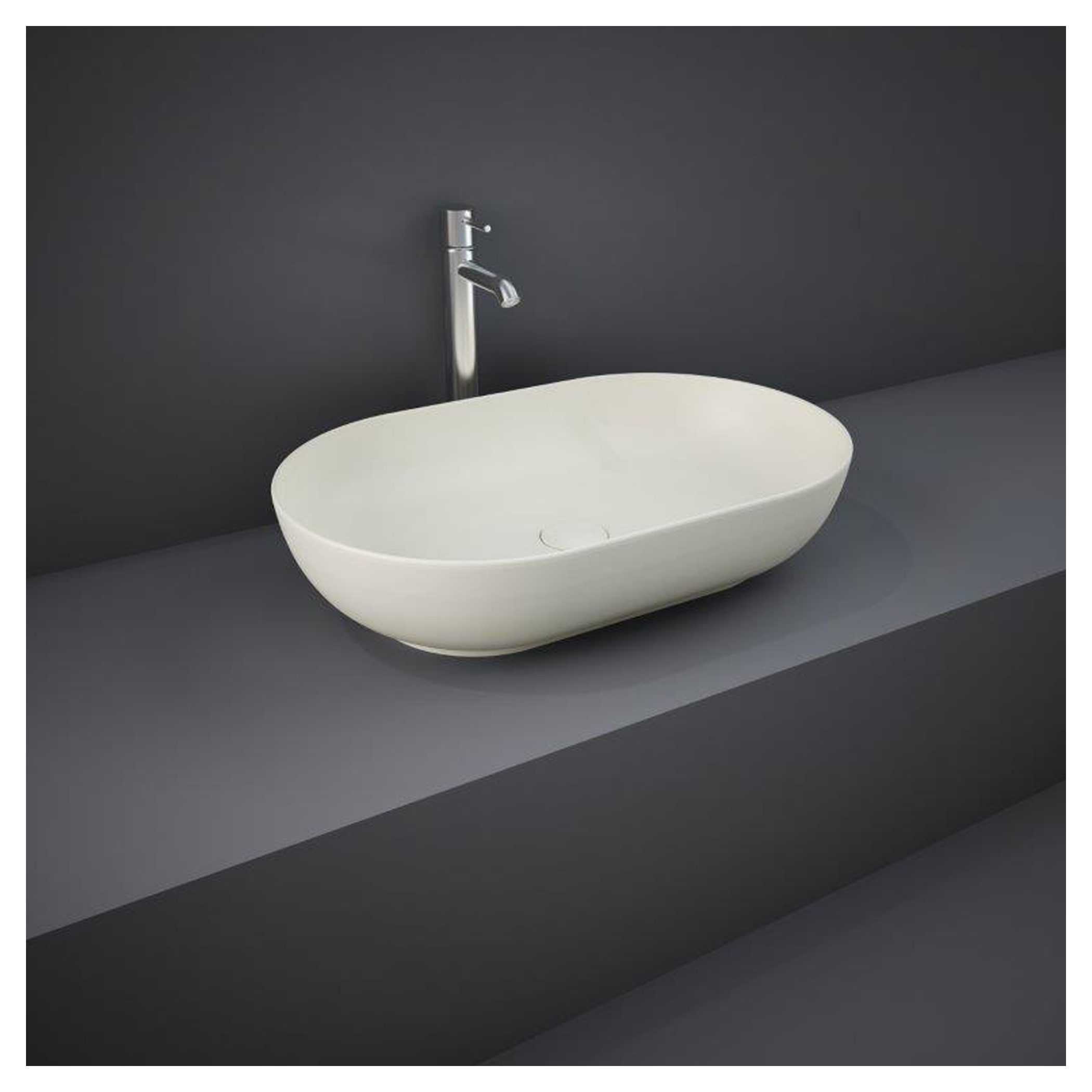 Sleek oval white bathroom sink with modern chrome faucet on grey countertop, ideal for contemporary bathroom designs emphasizing style and functionality.