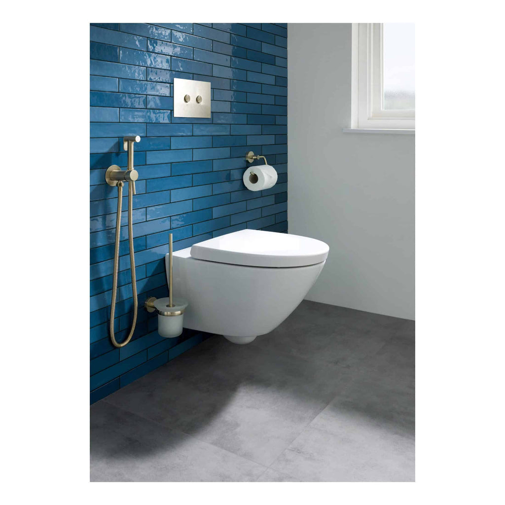 Sleek modern toilet with bidet attachments in a contemporary bathroom with blue subway tiles and natural light. Perfect for stylish and functional bathroom upgrades.