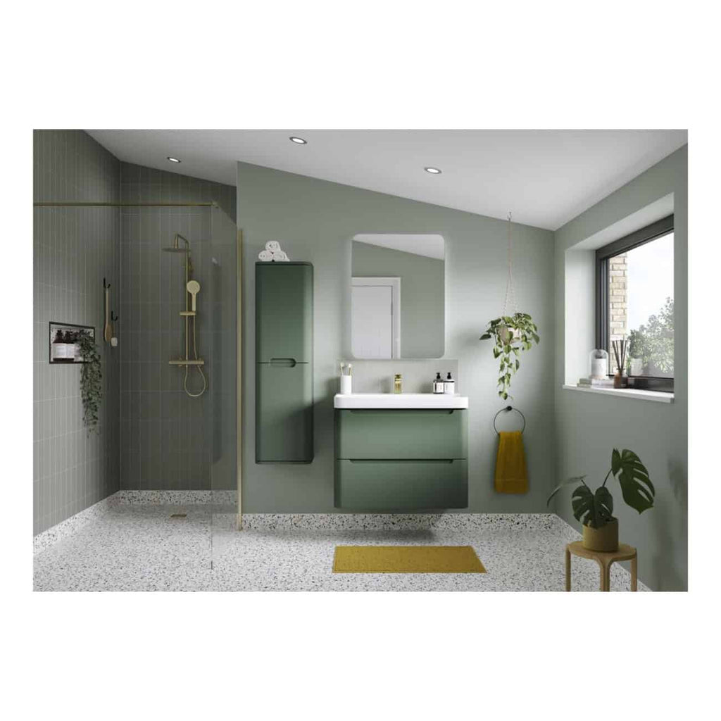 Modern green bathroom with a sleek vanity and hanging plants, featuring a walk-in shower with grey tiles and gold fixtures, illuminated by natural light through a large window.