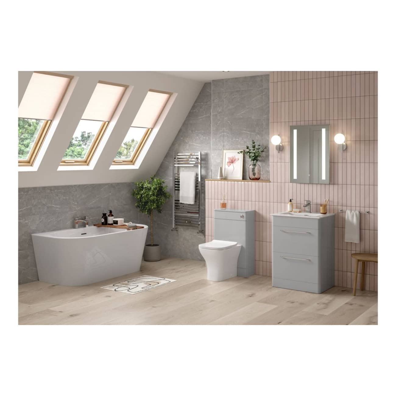 Sleek modern bathroom with skylight windows, featuring a white freestanding bathtub, a smart toilet, grey and pink tiled walls, and contemporary vanity units, creating a stylish and functional space.
