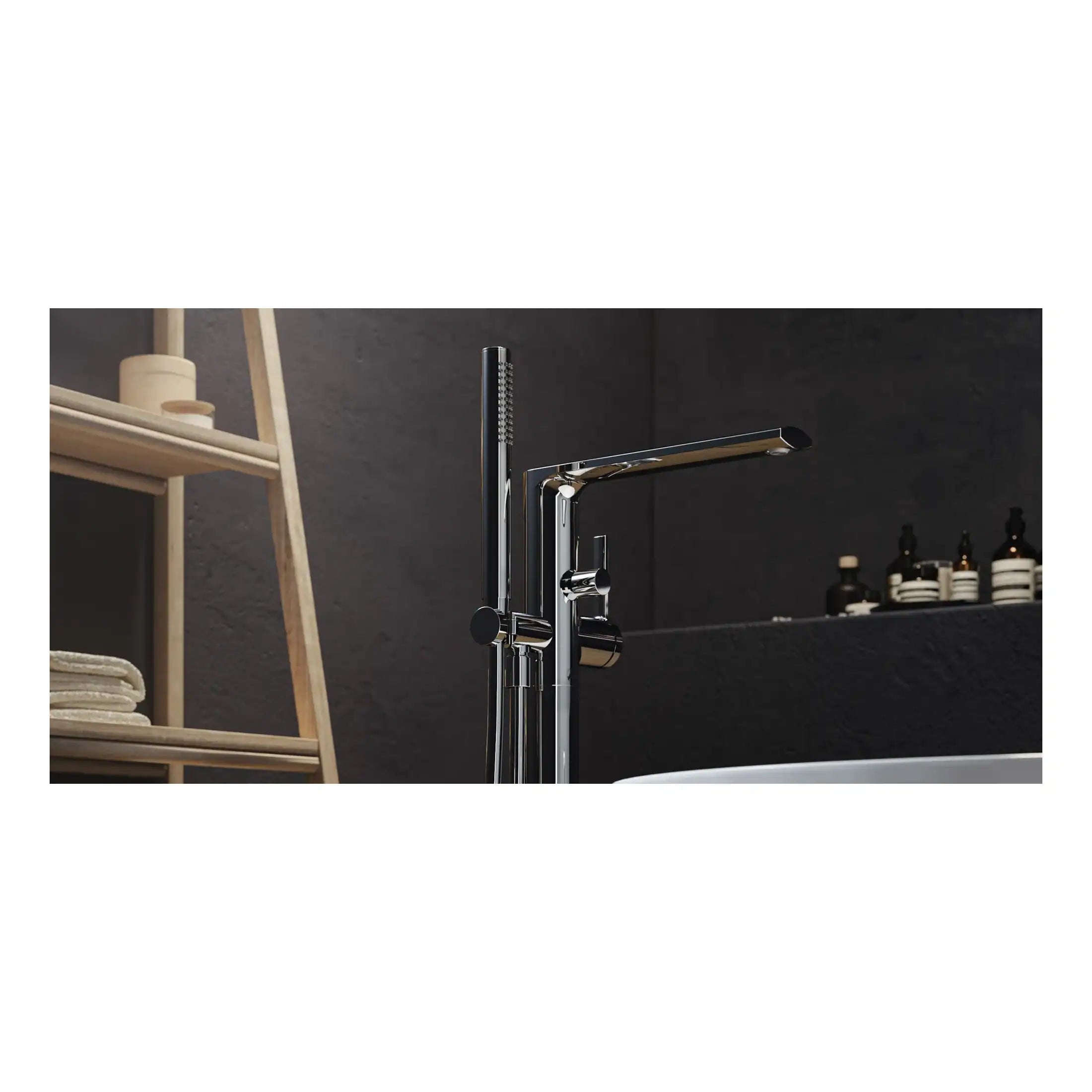 Sleek modern chrome bathroom mixer tap with handheld shower head and flexible hose, mounted on a dark grey wall in a contemporary bathroom setting.