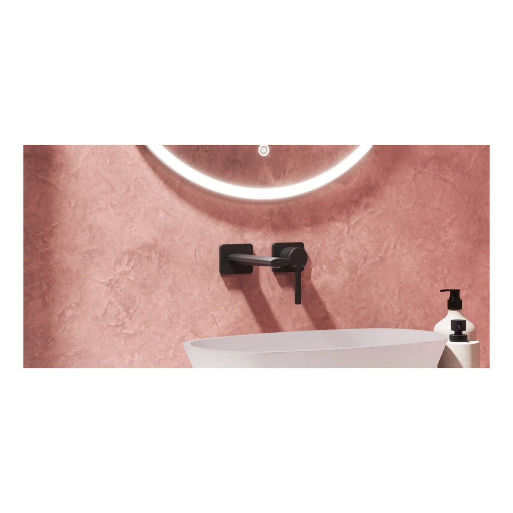 Modern matte black wall-mounted bathroom faucet above a stylish oval vessel sink with pink textured backsplash, minimalist design, and ambient lighting in a contemporary bathroom setting.