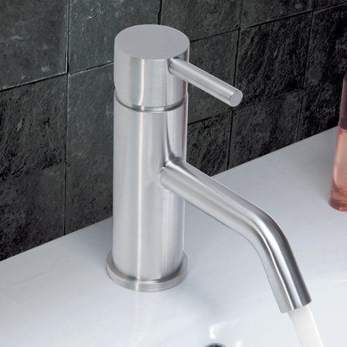 Modern stainless steel bathroom faucet with sleek design on white countertop, perfect for contemporary bathroom decor.