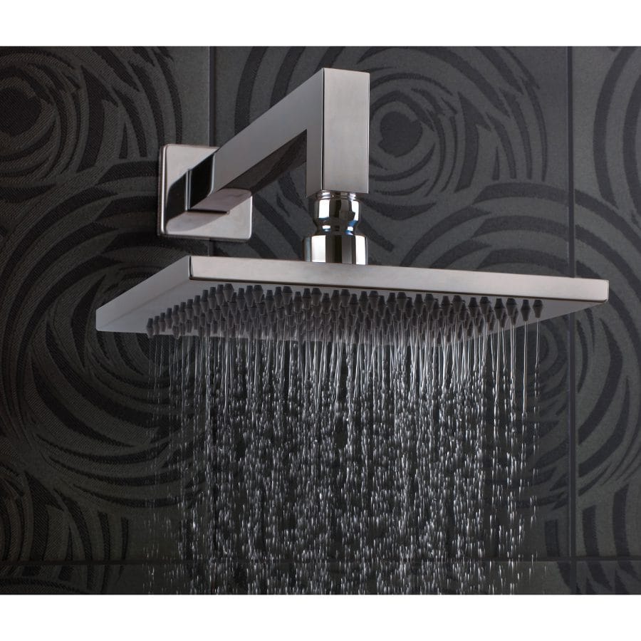 Modern chrome rain shower head in a contemporary bathroom with dark textured tiles.