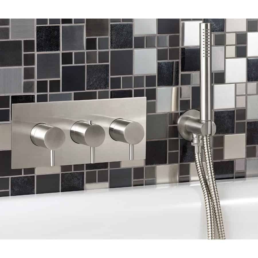 Rectangular modern shower panel with black, grey, and white mosaic tiles in the background, featuring sleek silver controls and handheld showerhead, perfect for contemporary bathroom design.