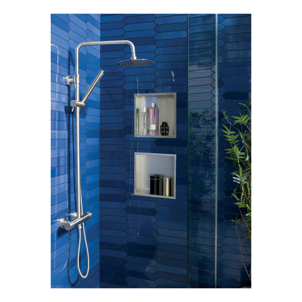 Shower with chrome fixtures and dark blue tiled wall in a modern bathroom, featuring recessed shelving for toiletries. Perfect for contemporary Bubly bathroom designs and stylish bathroom renovations.