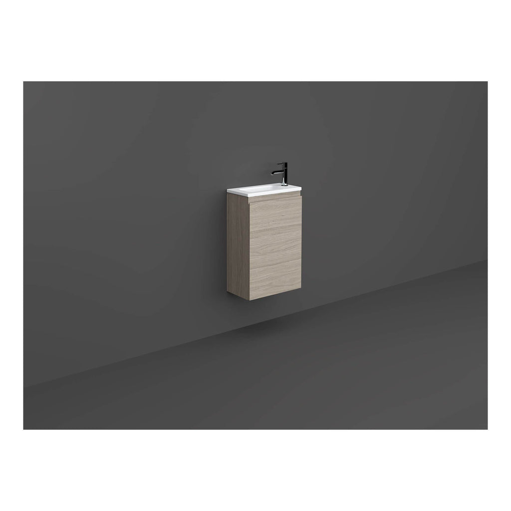 Minimalist wall-mounted bathroom wash basin with integrated cabinet in light wood finish and black modern tap, suitable for contemporary bathroom designs.