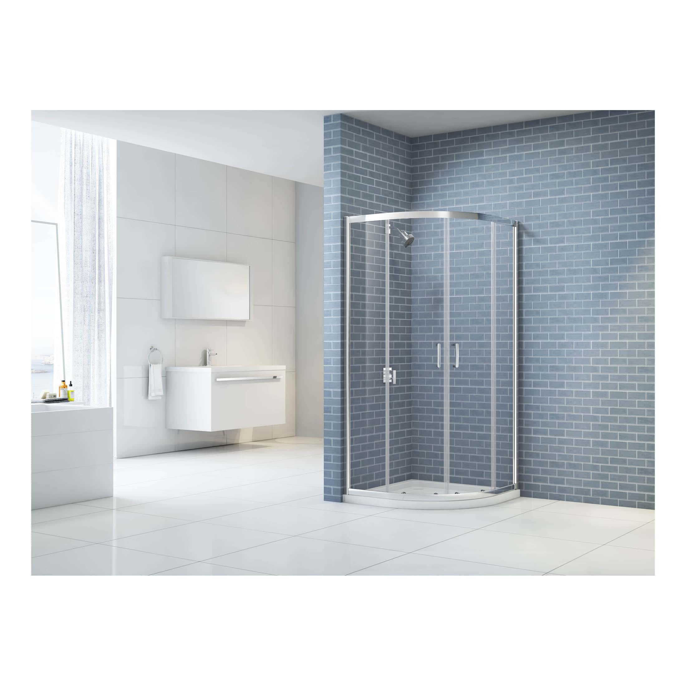 Shower enclosure with clear glass doors in a modern bathroom featuring light grey and blue tiled walls. The minimalist design enhances bathroom space with sleek fixtures for a contemporary look.