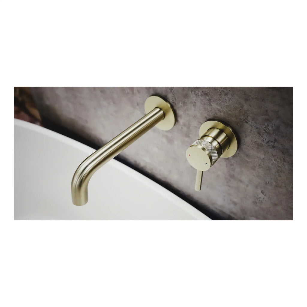 Sleek brushed gold wall-mounted bathroom faucet with a modern minimalist design, perfect for contemporary bathrooms. Featuring a single lever control for hot and cold water.