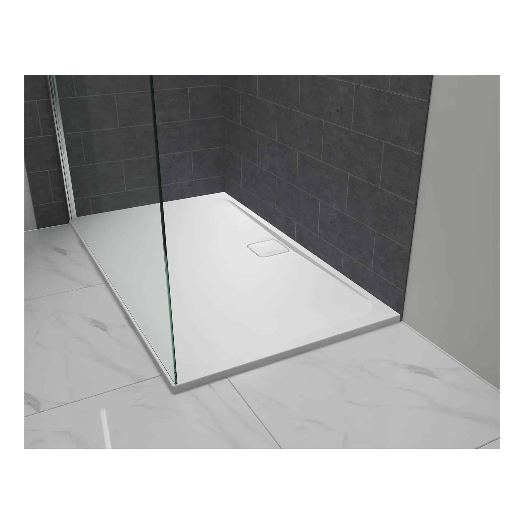 High-quality modern shower tray with clear glass panel, dark tiled wall background, and sleek bathroom design for a stylish, functional bathroom renovation.