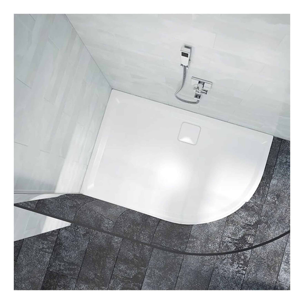 A modern white shower tray installed in a bathroom with grey tiled flooring and a wall-mounted shower fixture. The design emphasizes contemporary bathroom and shower solutions for stylish interiors.