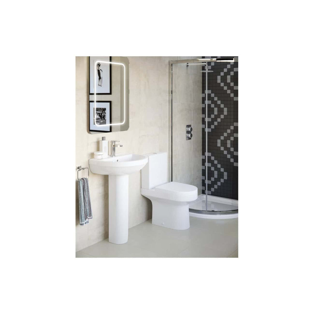 Sleek modern bathroom with white fixtures, illuminated mirror, and stylish shower enclosure featuring geometric black and grey tile design, perfect for contemporary bathroom aesthetics.