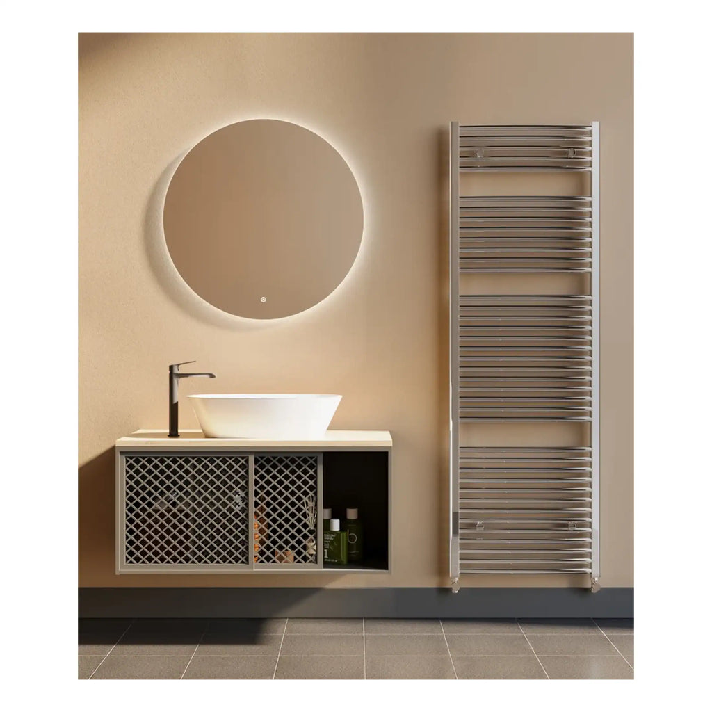 Elegant modern bathroom with wall-mounted vanity unit, vessel sink, round backlit mirror, and stainless steel towel radiator, creating a stylish and functional space.