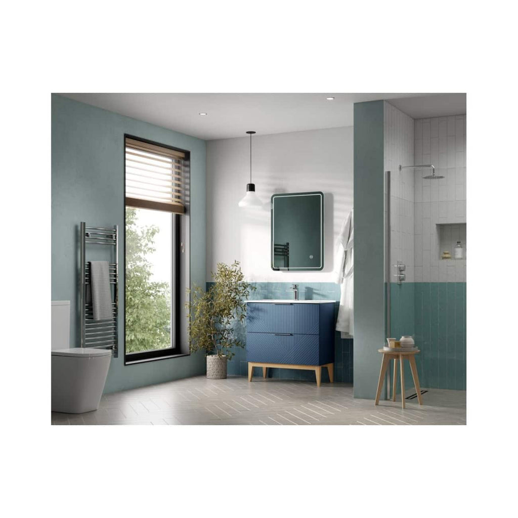 Bright bathroom with modern blue vanity, large window with wooden blinds, white tiled shower area, and stylish decor for a contemporary bathroom look.