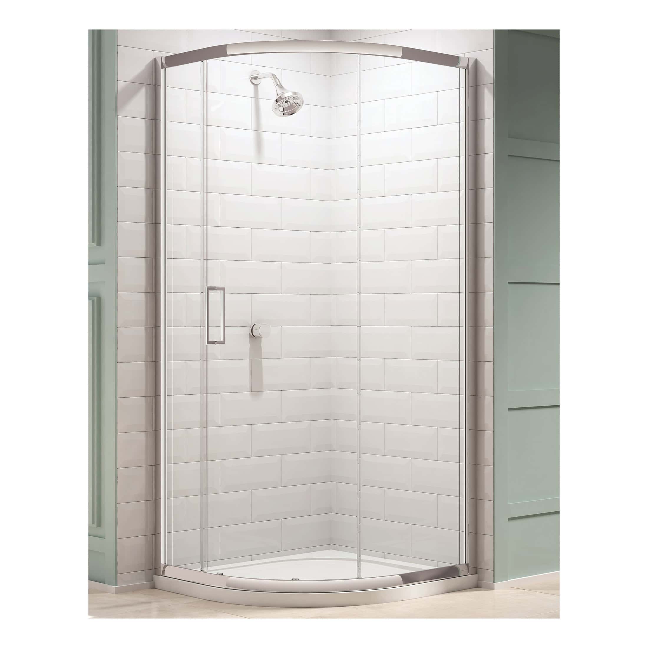 Shower enclosure with curved sliding glass doors, chrome frame, and white tiled wall background, part of Bubly Bathrooms' modern bathroom design.
