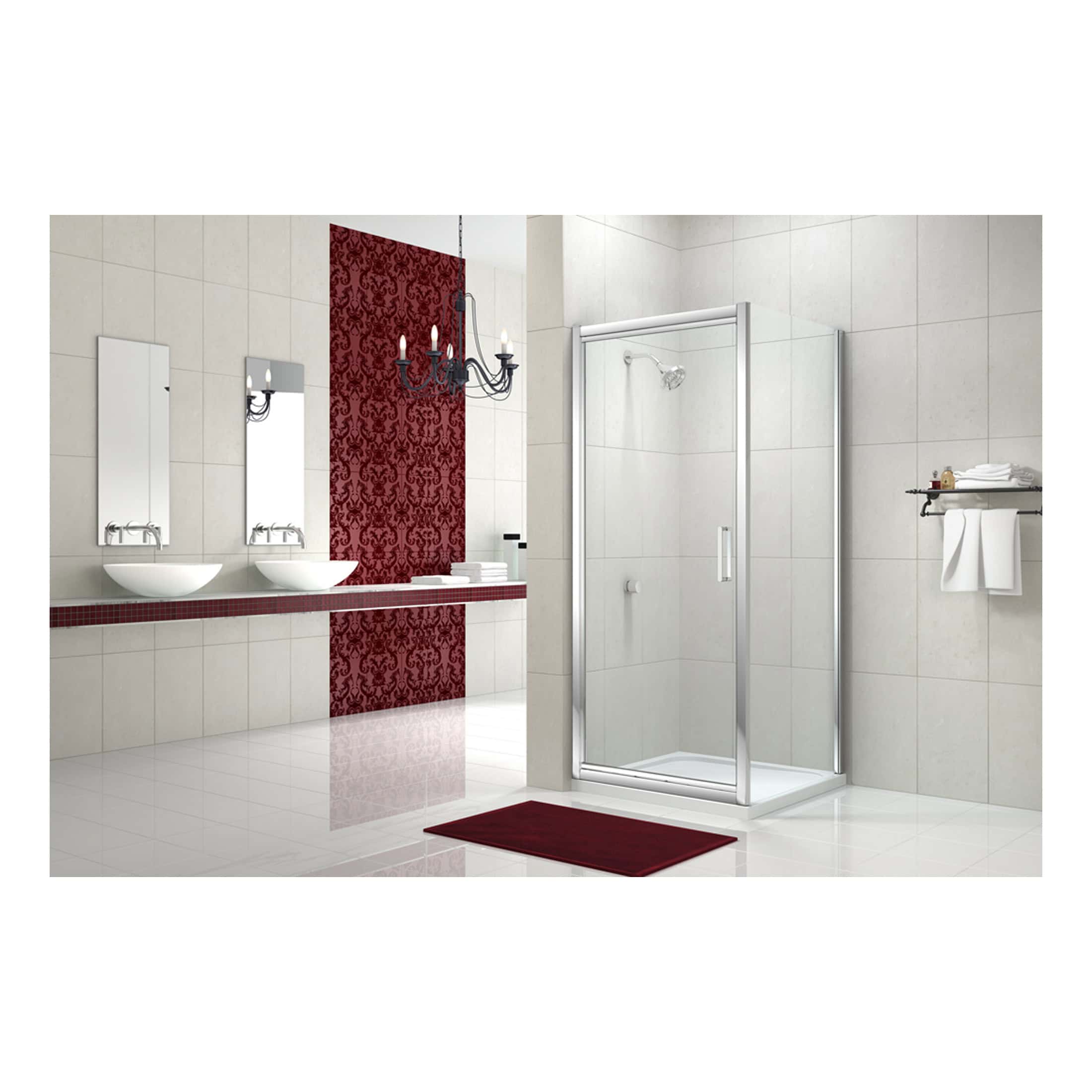 Modern bathroom with dual sinks, large mirror, red accent wall, chandelier, and a glass shower enclosure, showcasing sleek fixtures and elegant design for contemporary bathroom renovation.