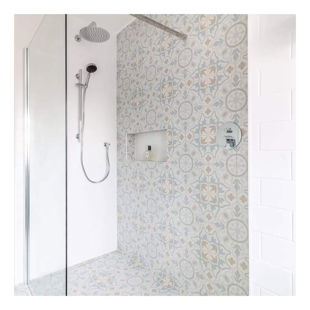 Modern walk-in shower with patterned tile wall, dual shower heads, and minimalist design for luxury bathroom renovation.