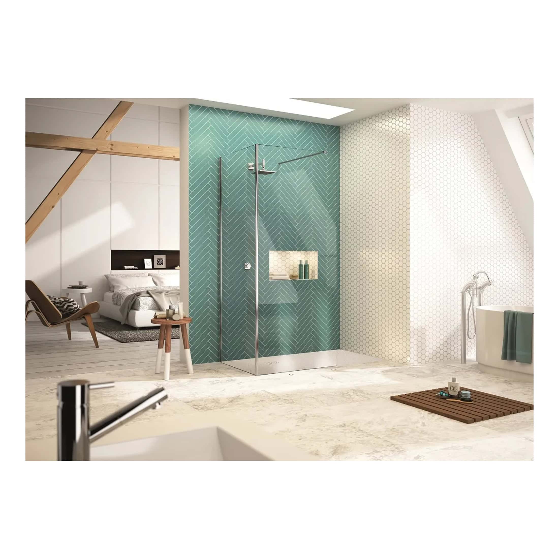 Modern bathroom with walk-in shower featuring teal herringbone tiles, adjacent bathtub, and sleek fixtures; combines contemporary design with natural light for a stylish, relaxing bathroom space.