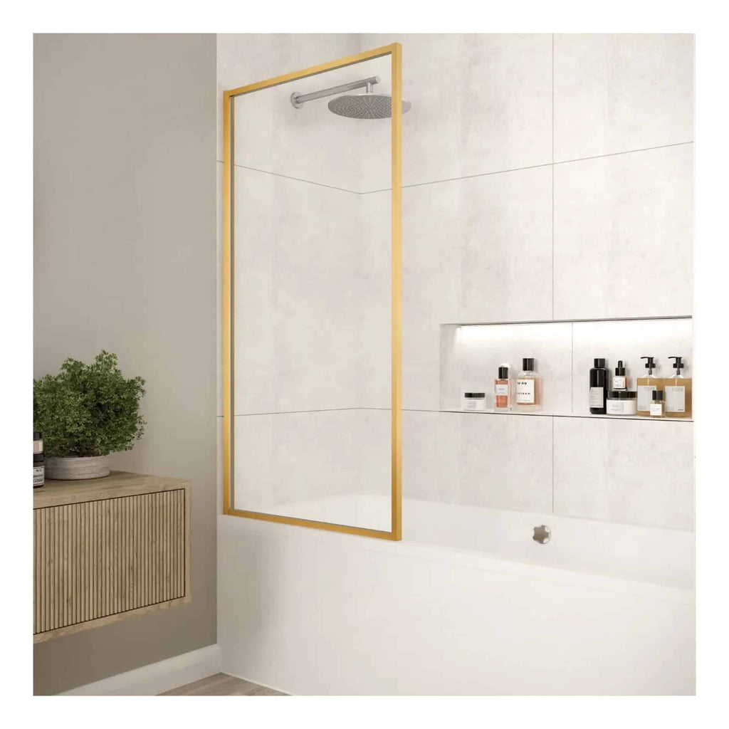Sleek walk-in shower with glass panel and modern chrome rainfall showerhead, framed by gold accents, in a contemporary white bathroom with recessed niche for toiletries.