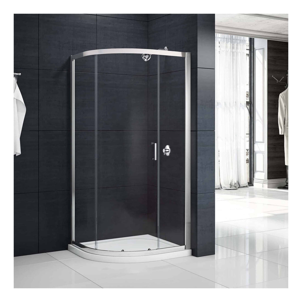 Shower enclosure with curved glass doors and chrome frame in modern bathroom setting.