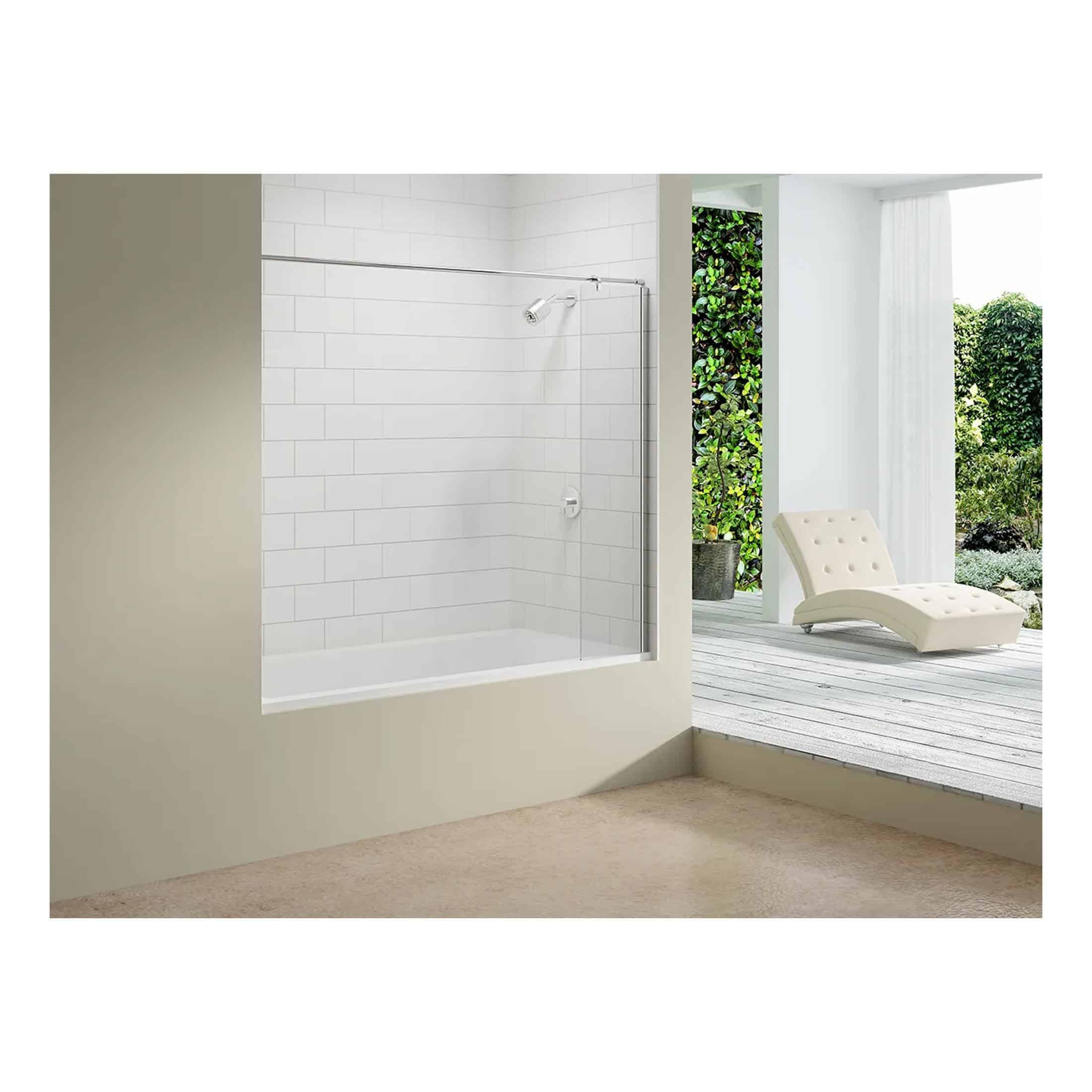 Modern white corner shower enclosure with glass door and tiled interior installed on a bathroom floor next to an outdoor patio with a lounge chair and lush greenery.