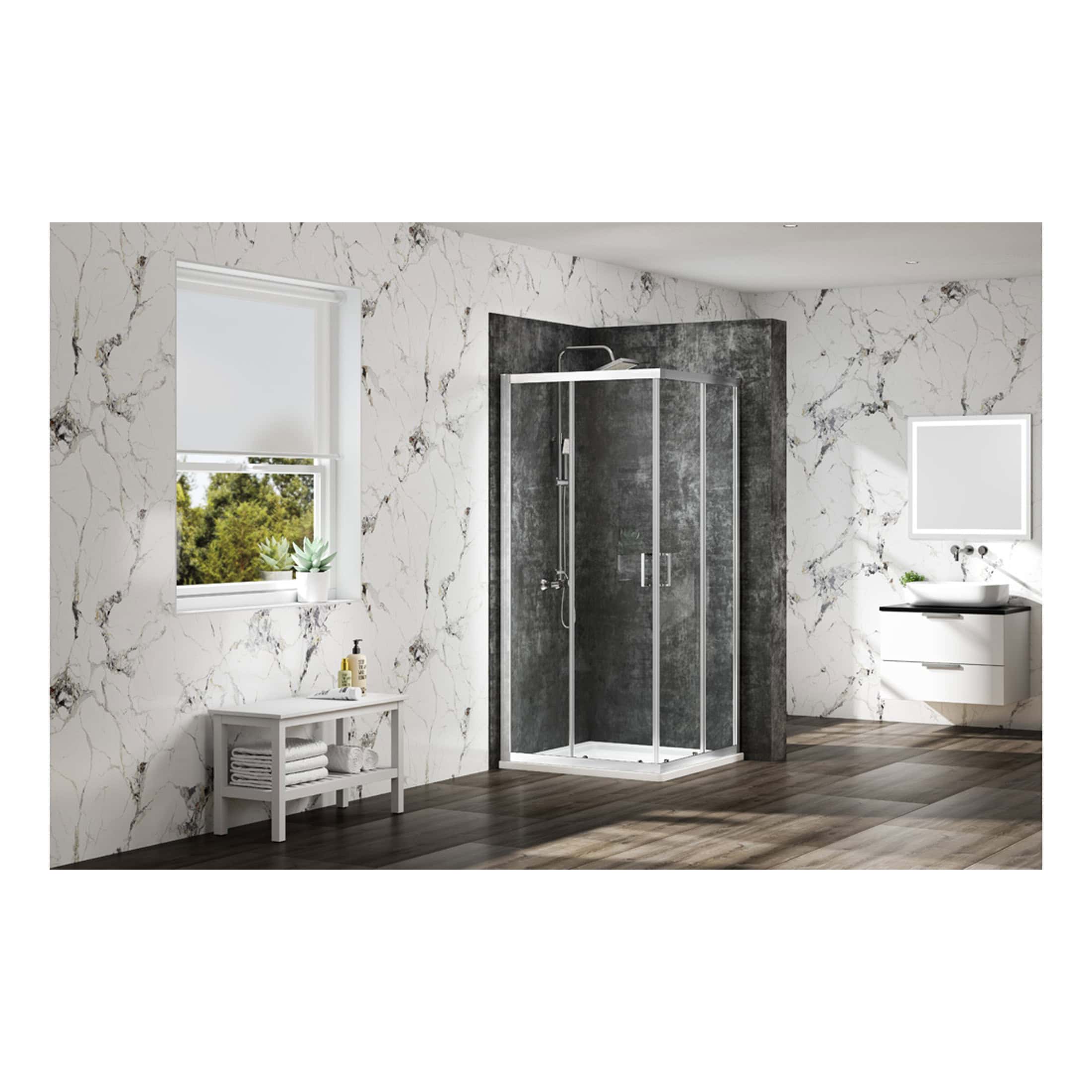 Modern bathroom with a sleek black and silver shower enclosure set against marble wall tiles, a white vanity with basin, and a small white table with towels and plant for stylish bathroom decor.