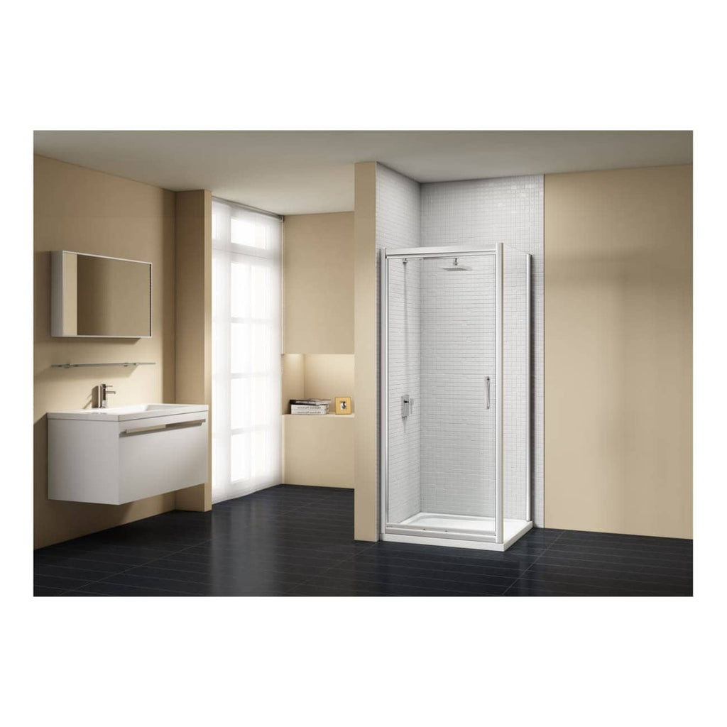 Modern beige bathroom with a sleek wall-mounted vanity, large mirror, and a spacious glass shower enclosure featuring chrome framing, creating a clean and contemporary bathroom interior.
