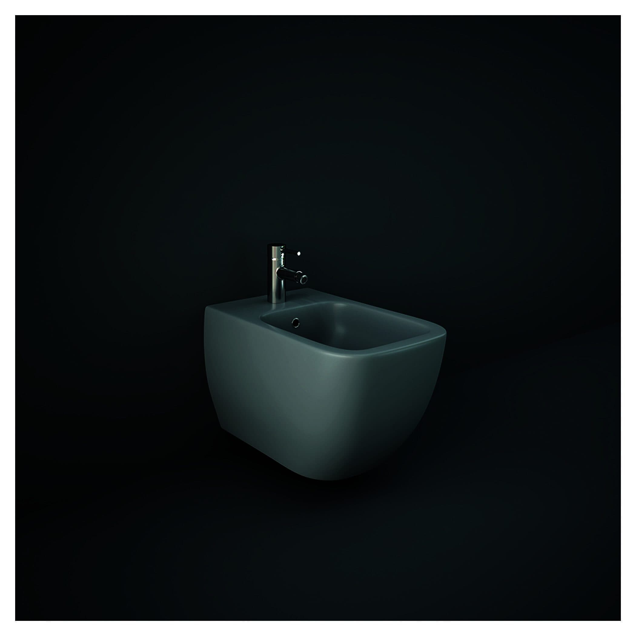 Sleek modern white bidet with chrome faucet installed against a dark minimalist background, showcasing contemporary bathroom fixtures.
