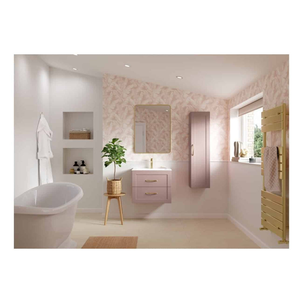 Luxurious modern bathroom featuring a freestanding bathtub, pastel pink vanity with gold handles, built-in shelves, potted plant, and a stylish radiator with towels, creating a relaxing and elegant spa-like atmosphere.