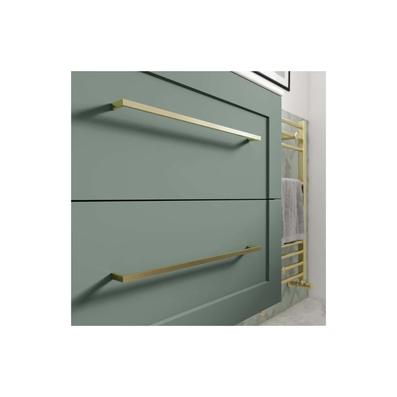 Brass bathroom drawer handles on a modern green vanity unit with gold towel rail in a contemporary bathroom setting.