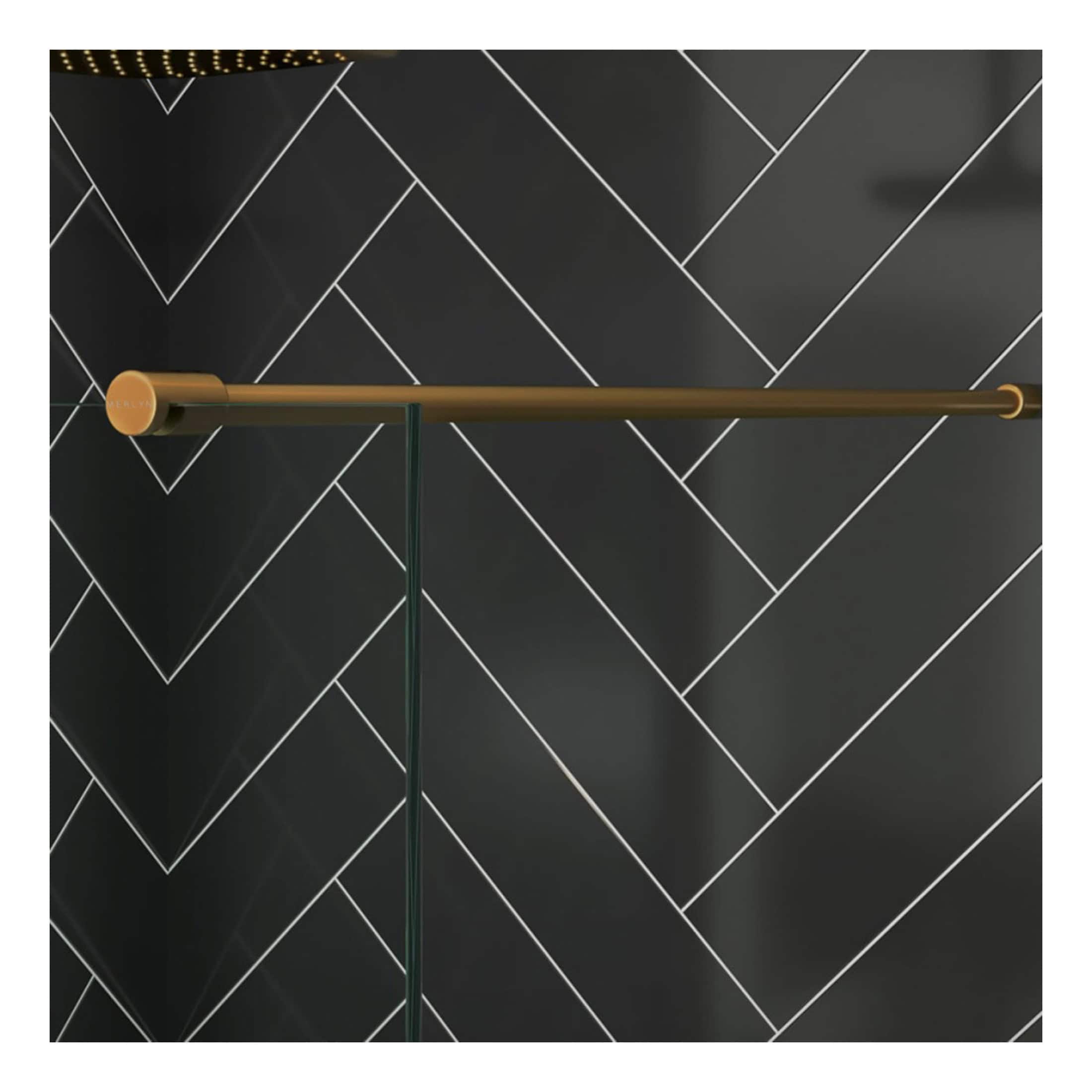 Sleek black tiled bathroom wall with modern, minimalist brass and glass towel rail. Stylish bathroom accessories perfect for contemporary bathroom decor.