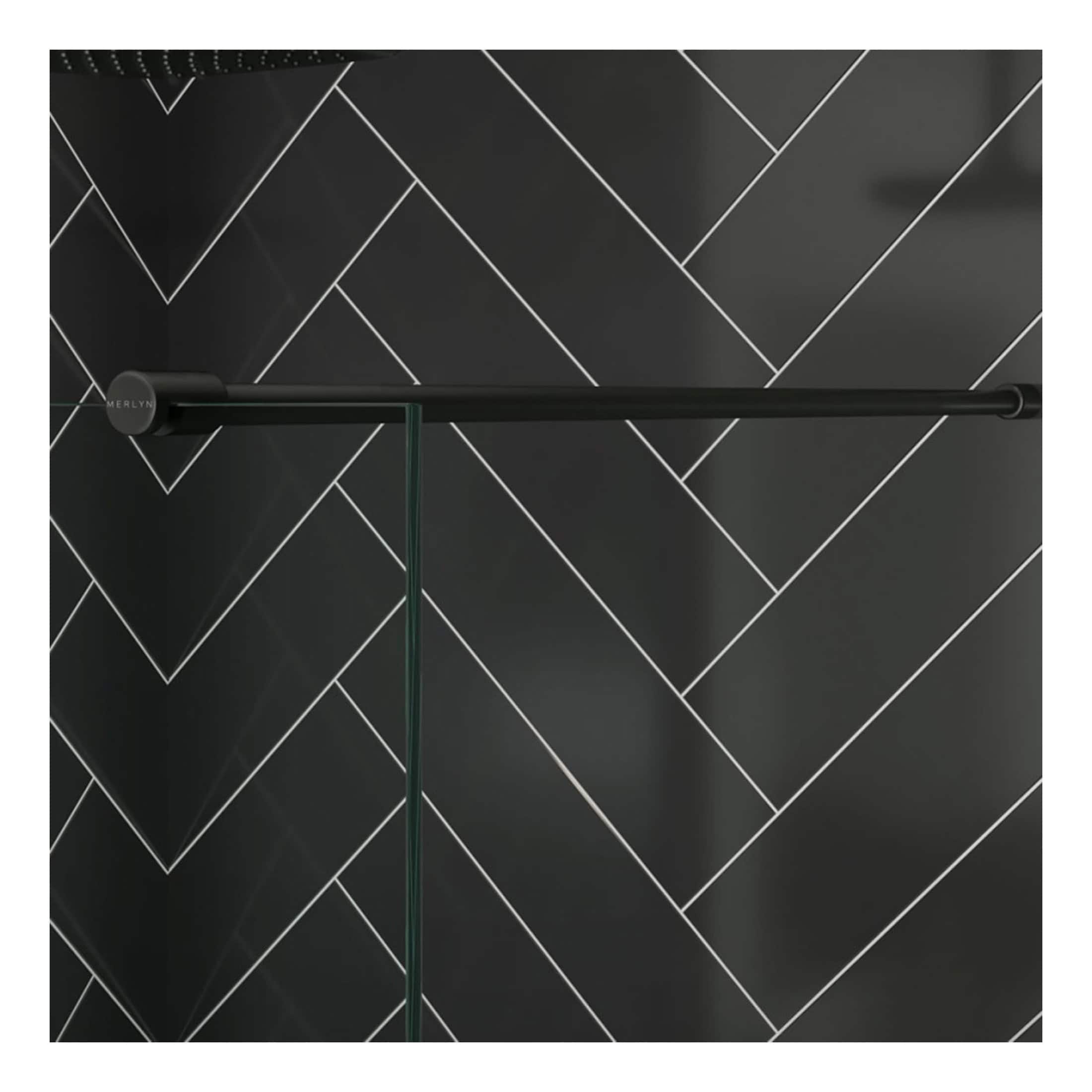 Black metal towel rail in a modern bathroom with sleek black and white herringbone tile wall. Stylish, functional bathroom accessory for a contemporary space.