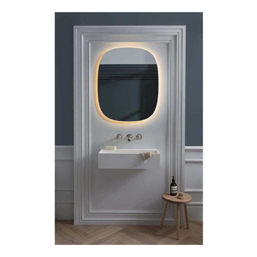 Minimalist bathroom vanity with oval backlit mirror, wall-mounted white sink, and vintage-inspired fixture, creating a modern and elegant space for bathroom decor.
