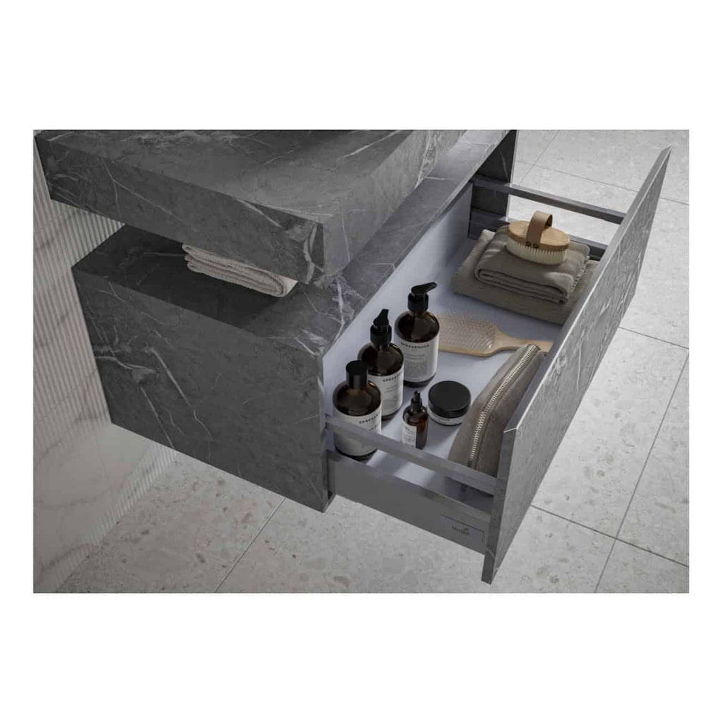 Elegant grey marble bathroom drawer with personal care products, towels, and grooming accessories for luxury bathroom organisation.