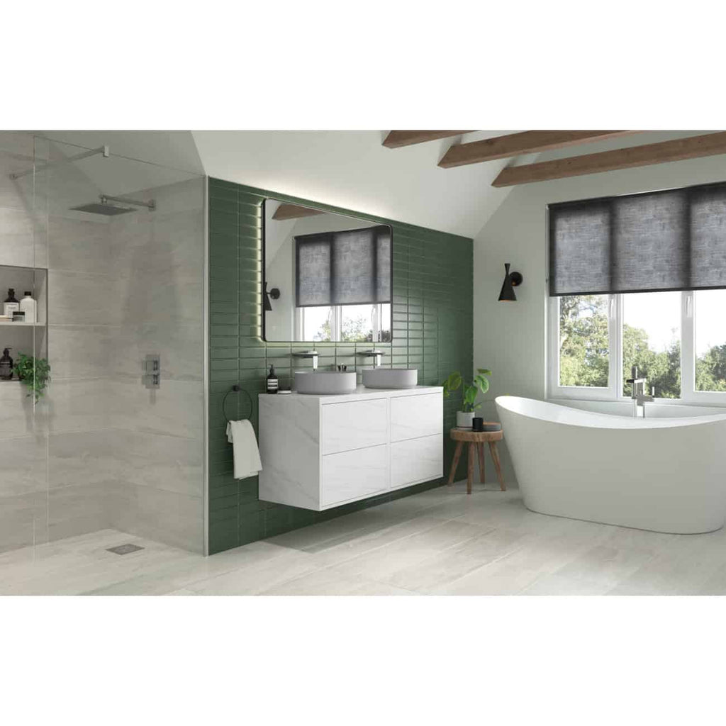 Sleek modern bathroom with a floating white vanity, dual vessel sinks, green tiled accent wall, freestanding bathtub, and large window with blackout blinds, creating a stylish and relaxing space.
