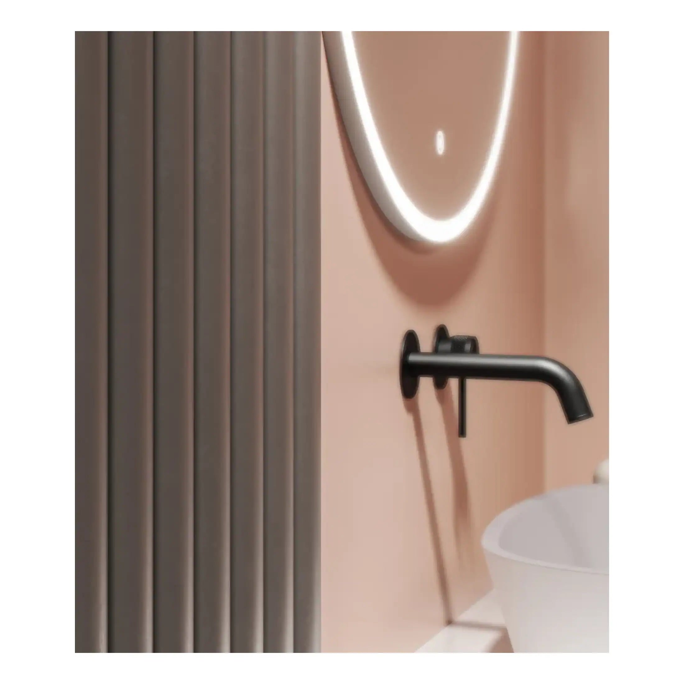 Modern bathroom with black wall-mounted faucet, round mirror with LED lighting, beige and pink colour scheme, and minimalist design elements.
