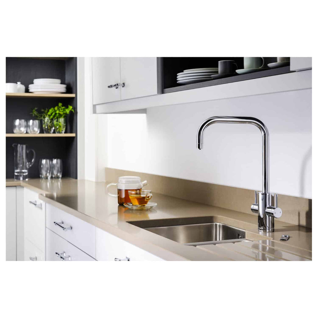 Sleek modern kitchen with stainless steel sink and chrome faucet, white cabinetry, black open shelving, and neatly arranged dishware, creating a clean and contemporary look.