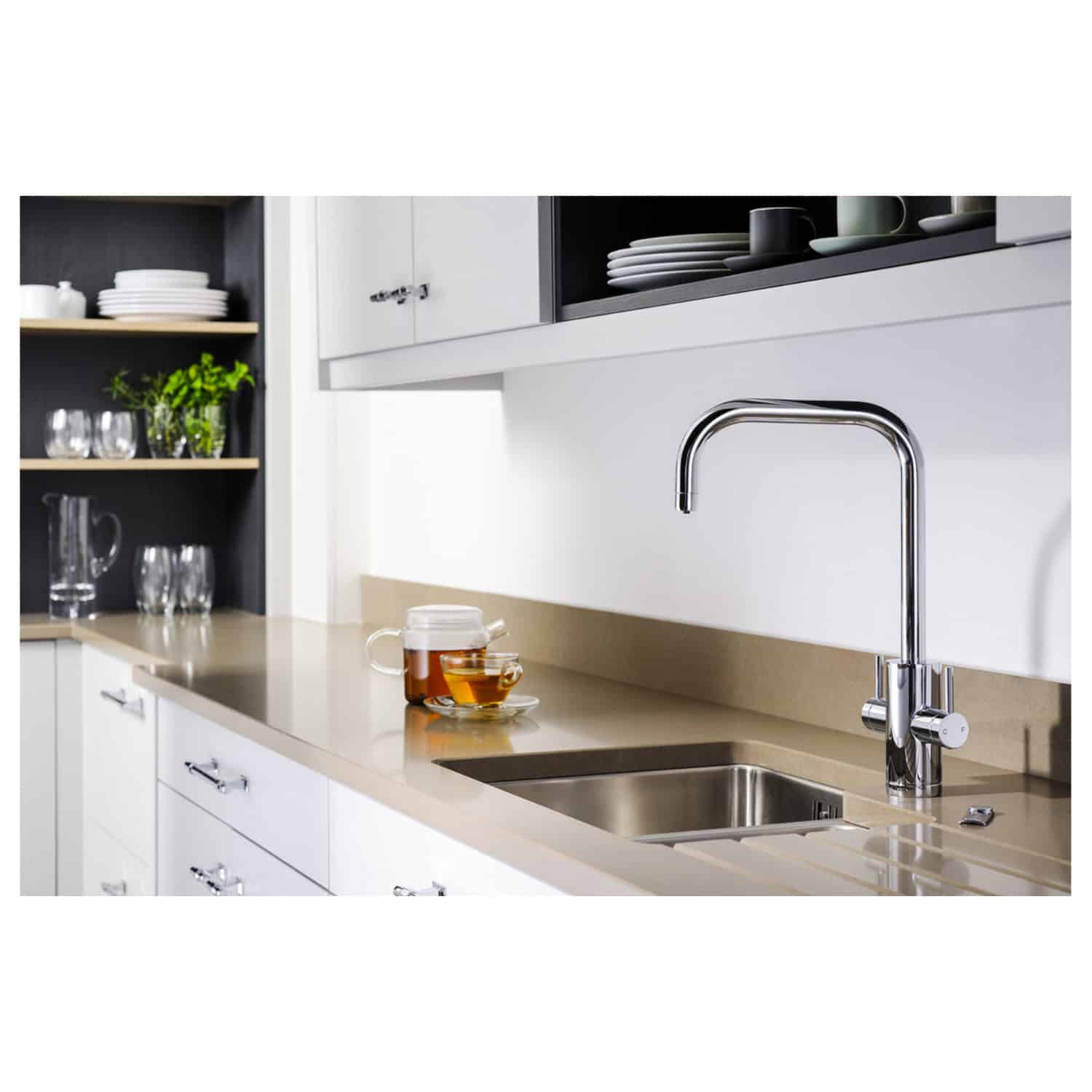 Sleek modern kitchen with stainless steel sink and chrome faucet, white cabinetry, black open shelving, and neatly arranged dishware, creating a clean and contemporary look.