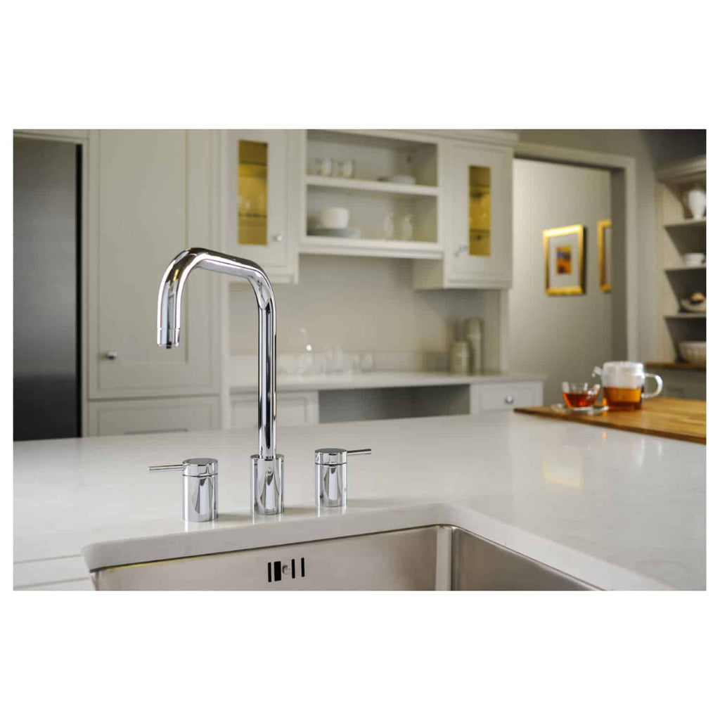 Sleek modern kitchen sink with chrome faucet and dual handles in a contemporary kitchen setting. Perfect for stylish bathroom or kitchen renovations.