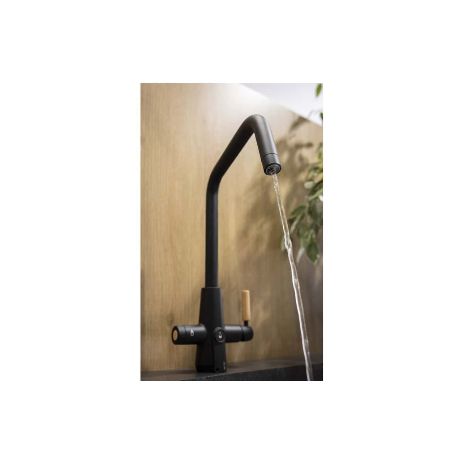 Sleek black kitchen tap with waterfall flow over a wooden backsplash, modern and stylish design, ideal for contemporary bathrooms and kitchens, durable and functional for everyday use.