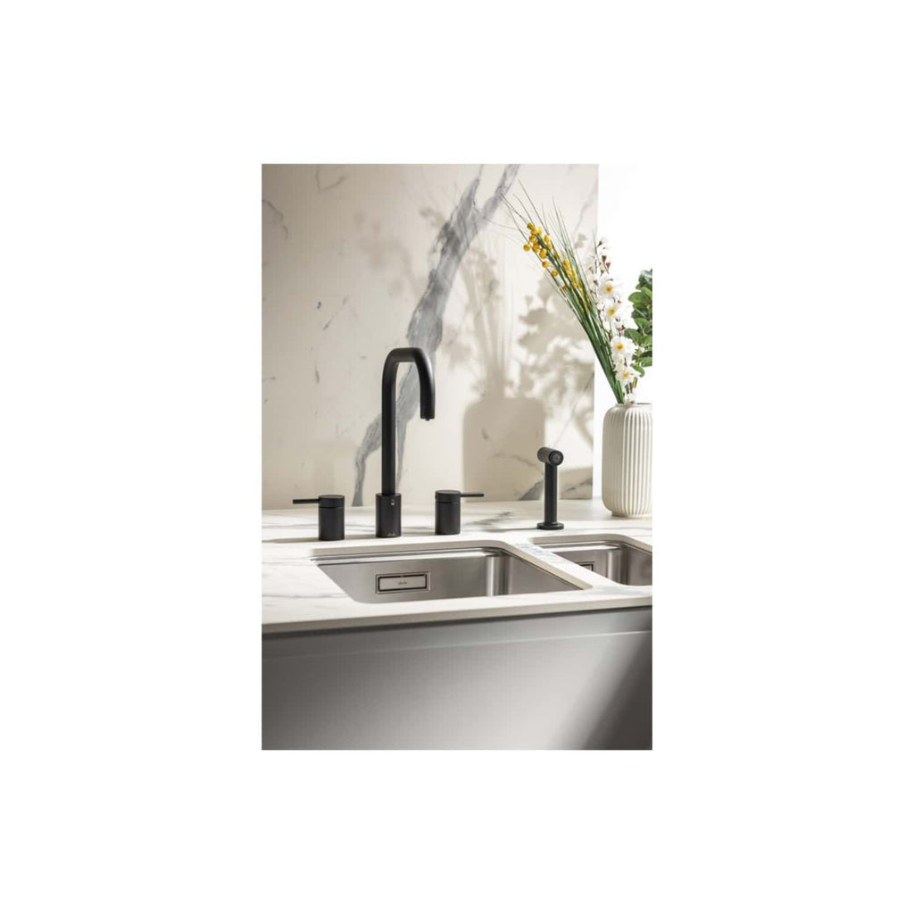Sleek black kitchen sink tap and accessories with marble countertop, modern design, stylish black fixtures, and elegant vase with flowers in a contemporary bathroom setting.