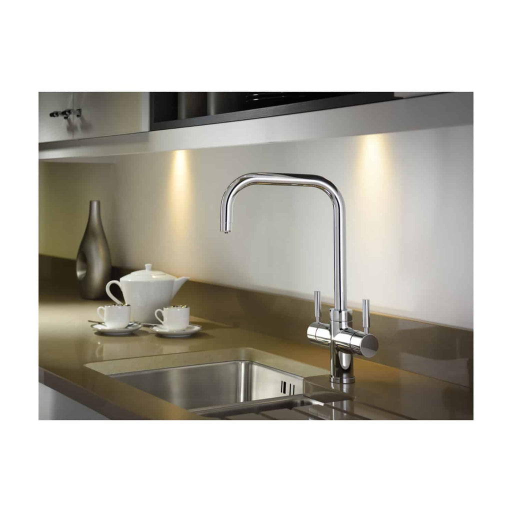 Sleek modern kitchen sink with chrome faucet and beige countertop, minimalist design, under-cabinet lighting, stylish tea set, and decorative vase, ideal for contemporary bathroom or kitchen renovation images.