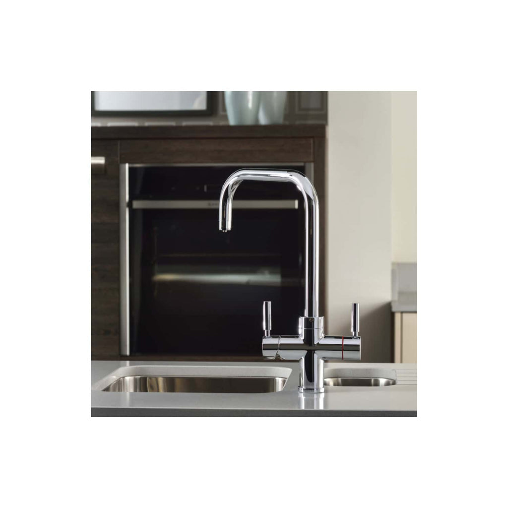 Sleek modern chrome kitchen tap with pull-out spray, installed over double stainless steel sinks in a contemporary kitchen setting.
