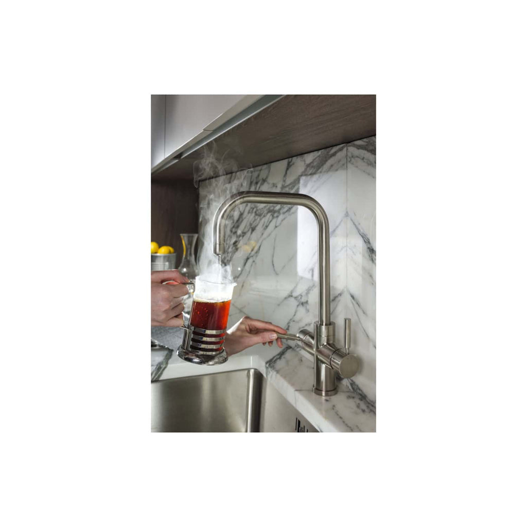 Futuristic stainless steel kitchen tap with hot and cold water controls, installed on a marble countertop, boiling water steaming from a stylish coffee cup, modern kitchen with marble backsplash, high-quality design.